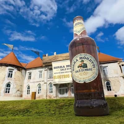 Bottled Beer Emerges From Castle in a fake-out-of-home ad of Birra Moretti