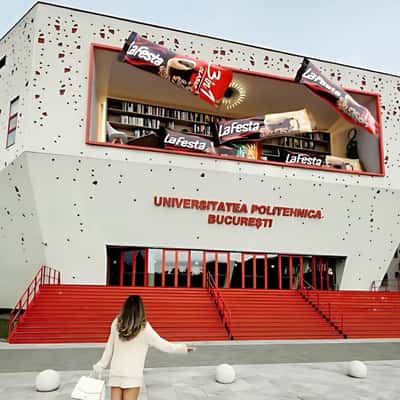 Coffee Packets Float at School Building in a fake-out-of-home ad of La Festa