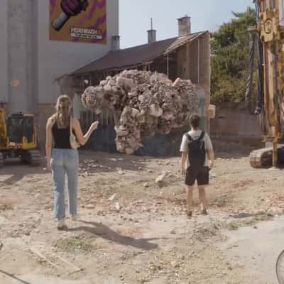 Stones Forming a Beckoning Hand in a fake-out-og-home ad of HORNBACH