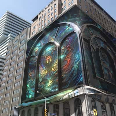 Stained Glass Façade Revealed at Hotel in a fake-out-of-home ad of Zedd