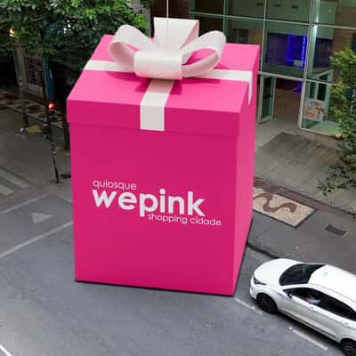 Heart Balloon Carries Pink Gift Box in a fake-out-of-home ad WEPINK