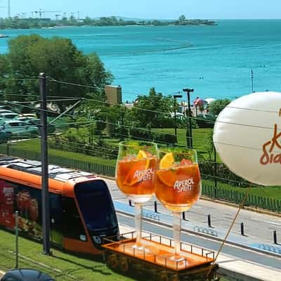 Glasses Riding on Tram in a fake-out-of-home ad of Aperol Spritz