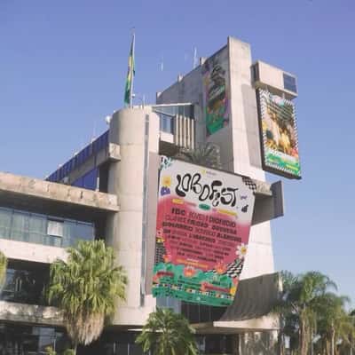 Poster and Screen Ads Hang on Building in a fake-out-of-home ad of Lobofest