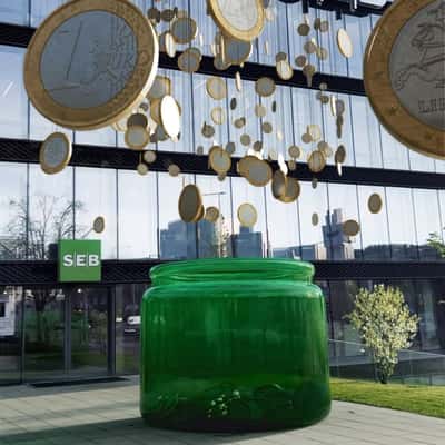 Coins On Thread Hangs Above A Jar in a fake-out-of-home ad of SEB