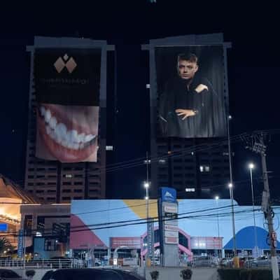 Billboards Waving on Buildings in a fake-out-of-home ad of Dr. Toni Amaral