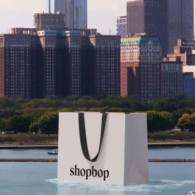 Shopping Bag Cruising on River in a fake-out-of-home ad of Shopbop
