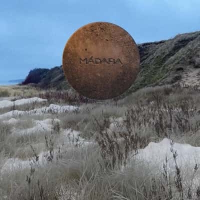 Floating Foundation Sparkles On Dry Grass in a fake-out-of-home ad of MÁDARA