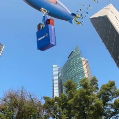 Airship Floats Above Skyscraper in a fake-out-of-home ad of Walmart