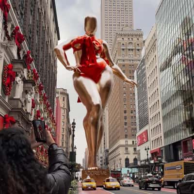 Golden Mannequin Pulled by Taxi Cabs in a fake-out-of-home ad of Adore Me