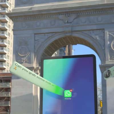 Message Bubbles Flow into the iPad in a fake-out-of-home ad of WhatsApp