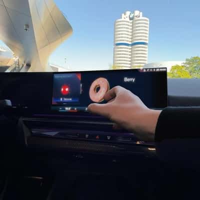 Donut Emerges From Dashboard Screen in a fake-out-of-home ad of BMW
