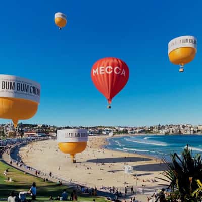 Cream Hot Air Balloons Float at Beach in a fake-out-of-home ad of Mecca