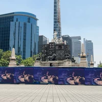 Electric Guitar Hangs on Angel Statue in a fake-out-of-home ad of Lenny Kravitz