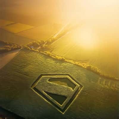 Logo Formed on Green Field in a fake-out-of-home ad of Superman