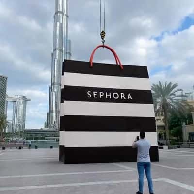 Crane Lowers Down Shopping Bag in a fake-out-of-home ad of Sephora