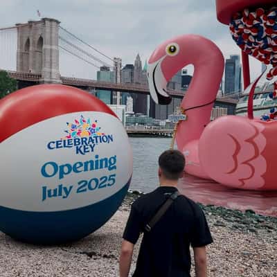 Beach Balls Dripping on Hourglass in a fake-out-of-home ad of Carnival Cruise