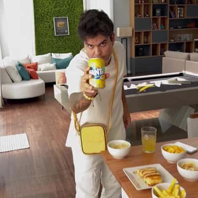 Soda Emerges from Cellphone in a fake-out-of-home ad of Fanta
