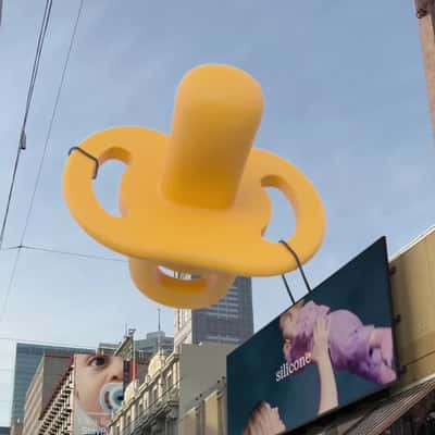 Soother Floats from City to Space in a fake-out-of-home ad of Tommee Tippee