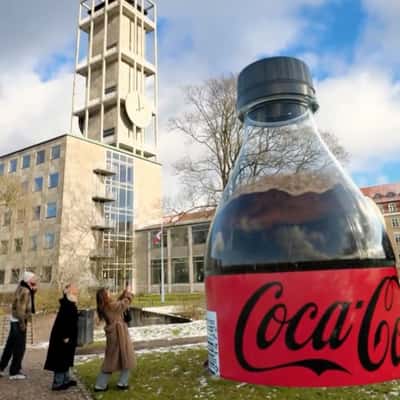 Plastic Bottle Emerges from the Ground in a fake-out-of-home ad of Coca-Cola
