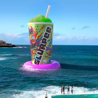 Slurpee Floats on an Inflatable Ring in a fake-out-of-home ad of 7-Eleven