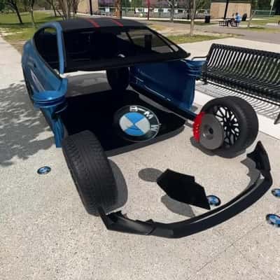 Car Assembles From BMW Button in a fake-out-of-home-ad of KIES Motorsports