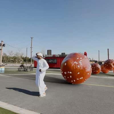 Man Chased by Rolling Delicacy in a fake-out-of-home ad of Last Exit Dubai