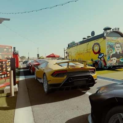 Sports Cars Line Up at Drive-Thru in a fake-out-of-home ad of Lobster & Co