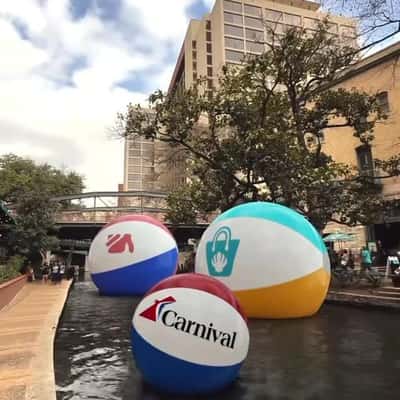 Beach Balls Float at River Walk in a fake-out-of-home ad of Carnival Cruise Lines
