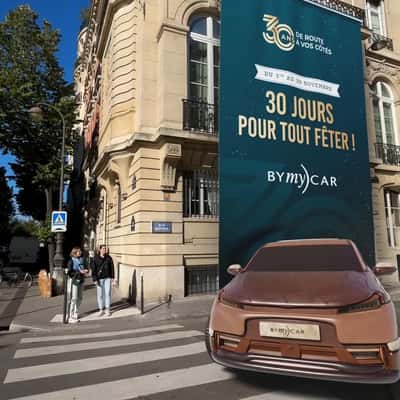 Car Emerges from Rolled-Down Billboard in a fake-out-of-home ad of BYmyCAR