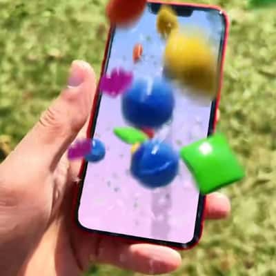 Candies Jump Out of Phone Screen in a fake-out-of-home ad of Candy Crush
