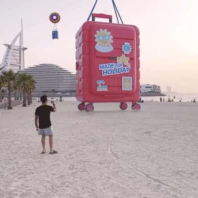 Suitcase on Inflatable Lands on Beach in a fake-out-of-home ad of Centrepoint