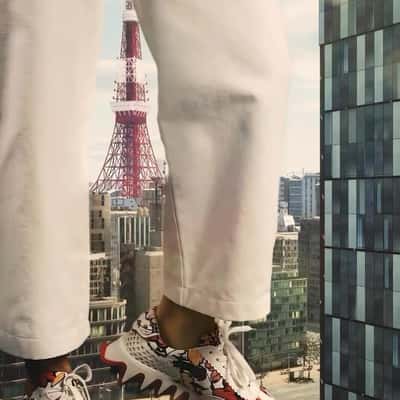 Giant in Sneakers on the Street in a fake-out-of-home ad of Christian Louboutin