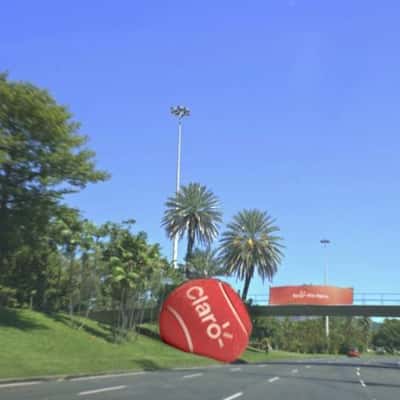 Red Tennis Ball Stuck on Footbridge in a fake-out-of-home ad of Claro