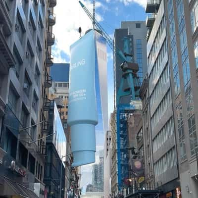 Crane Lowers Sunscreen onto the Street in a fake-out-of-home ad of Darling