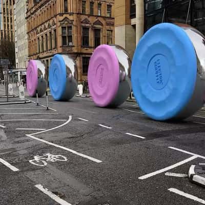 Rolling Shuffleboard Discs in a fake-out-of-home ad of Electric Shuffle
