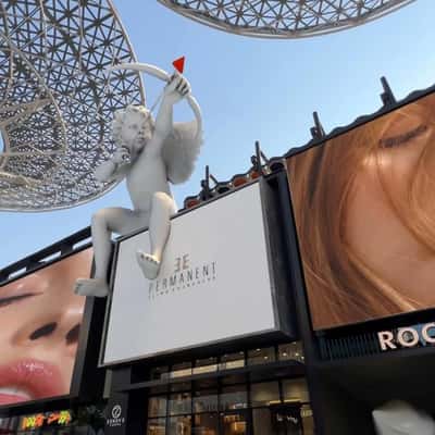 Cupid Shooting Arrows on Inflatable Lips in a fake-out-of-home ad of Elle Permanent