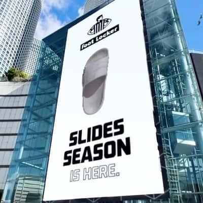 Sandals Burst Out from Digital Screen in a fake-out-of-home ad of Foot Locker