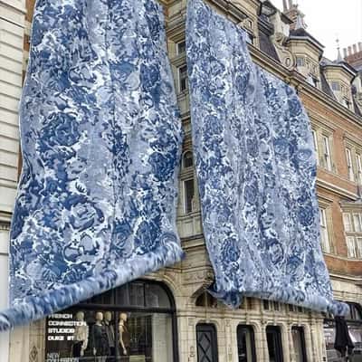 Fabric Rolls Down on Building in a fake-out-of-home ad of French Connection