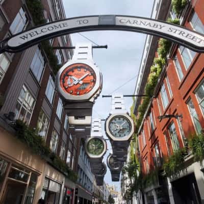Watches Hang Above a Shopping Street in a fake-out-of-home ad of G-SHOCK