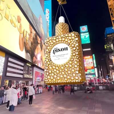 Hair Oil Bottle Lowered by Crane in a fake-out-of-home ad of Gisou