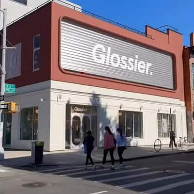 Lip Balm Fell from Store Facade in a fake-out-of-home ad of Glossier
