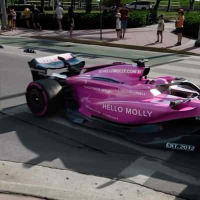 Cruising Pink-themed Formula-1 Car in a fake-out-of-home ad of Hello Molly
