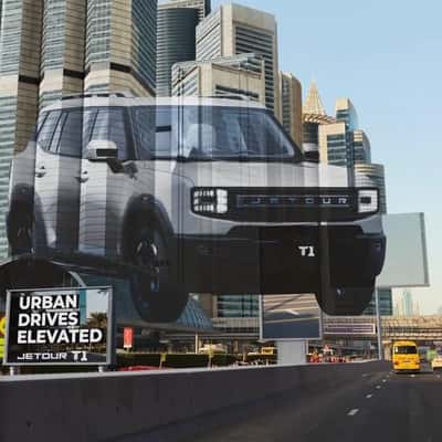 SUV Projected on Skyscrapers in a fake-out-of-home ad of Jetour