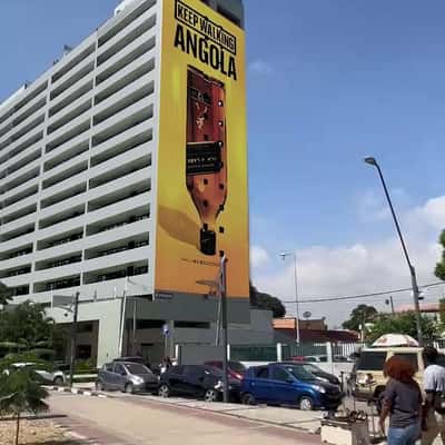 Whisky Bottle Emerges on Building in a fake-out-of-home ad of Johnnie Walker