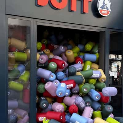 Puffer Jackets Spill Out from the Store in a fake-out-of-home ad of JOTT