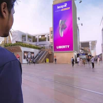 Sneakers Spill Out of Digital Screen in a fake-out-of-home ad of Liberty Shoes
