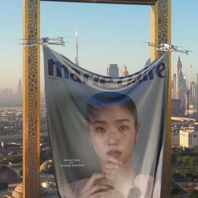 Drones Lift Magazine Cover Banner in a fake-out-of-home ad of Marie Claire