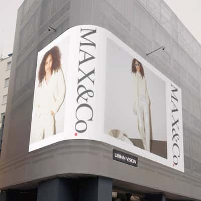 Digital Screen Spills Christmas Balls in a fake-out-of-home ad of MAX& Co.