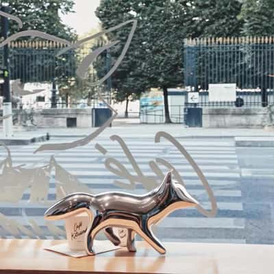 Silver Fox Spills Coffee Cup in a fake-out-of-home ad of Maison Kitsune