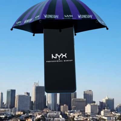 Smartphone Descends with Umbrella in a fake-out-of-home ad of NYX Cosmetics